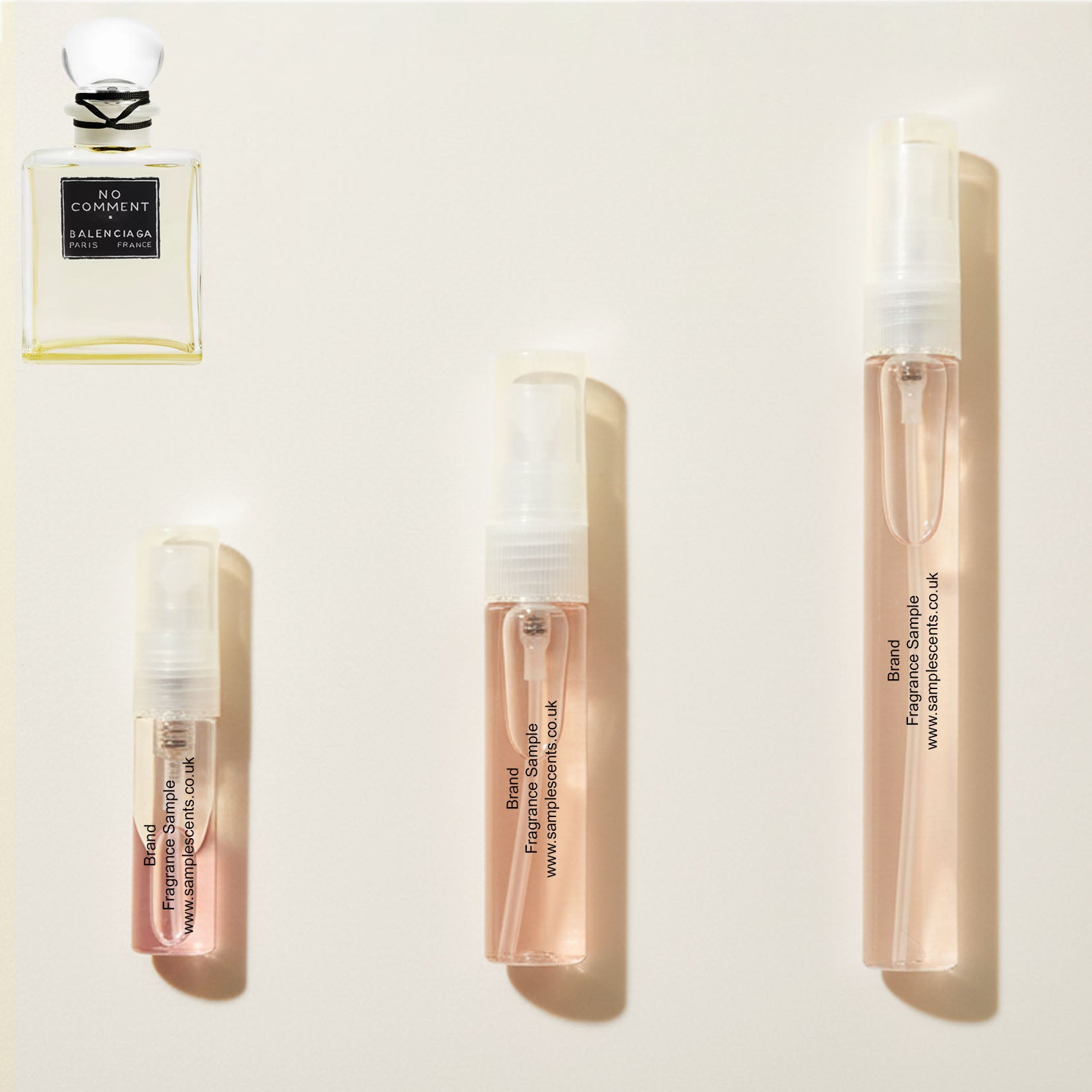 Perfume sample atomisers shown for size reference, hand-decanted from Balenciaga No Comment bottle.