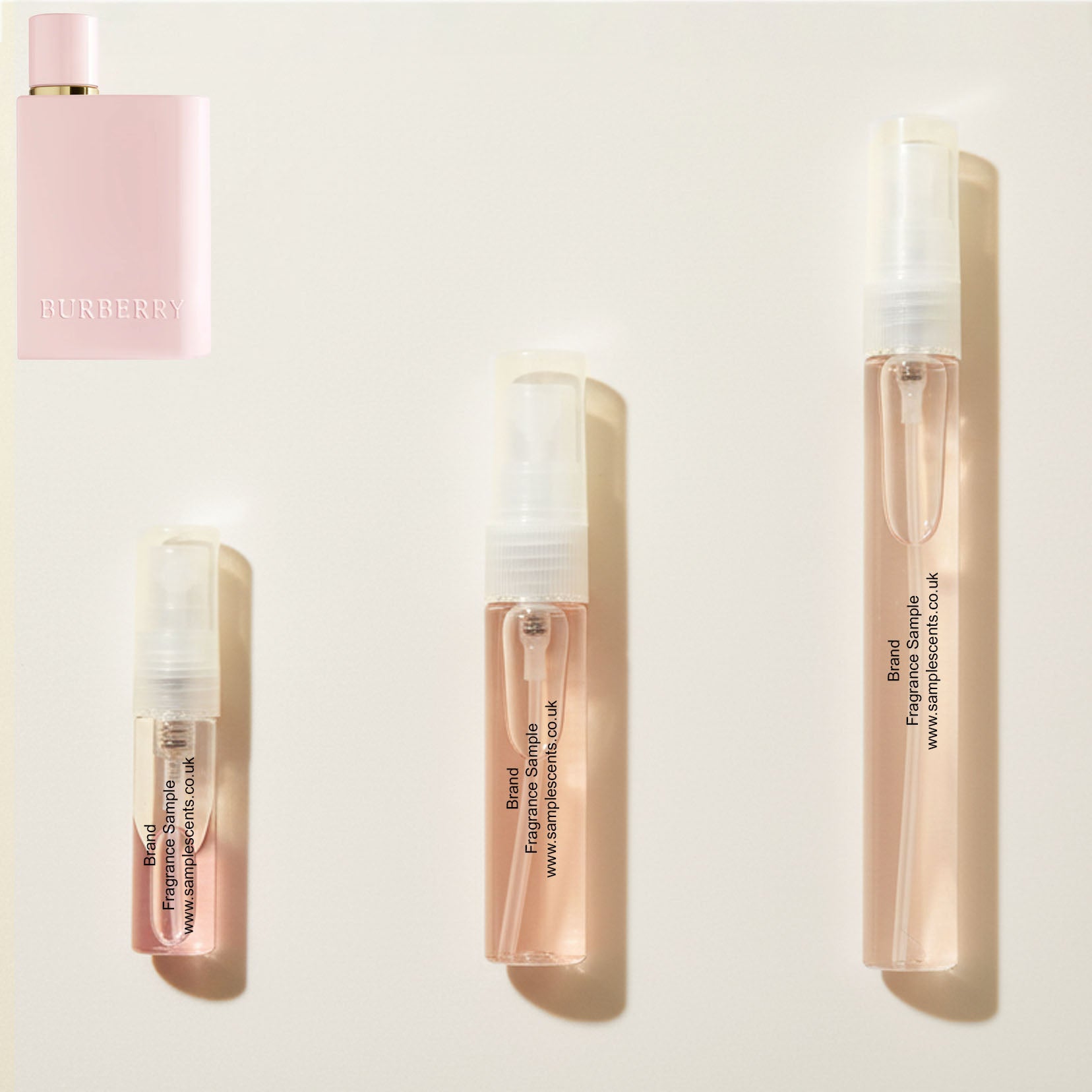 Perfume sample atomisers shown for size reference, hand-decanted from Burberry For Her Elixir bottle.