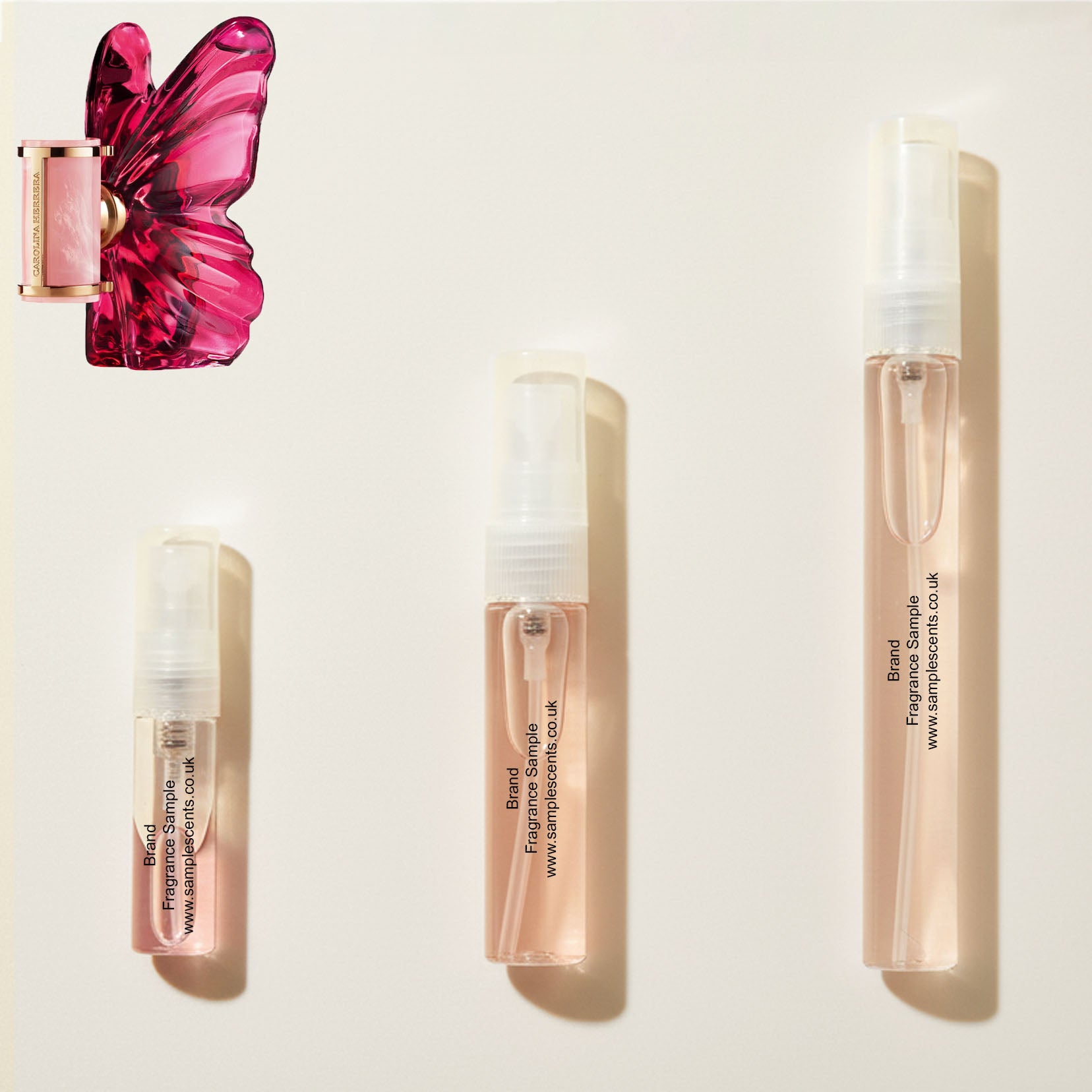 Perfume sample atomisers shown for size reference, hand-decanted from Carolina Herrera La Bomba bottle.