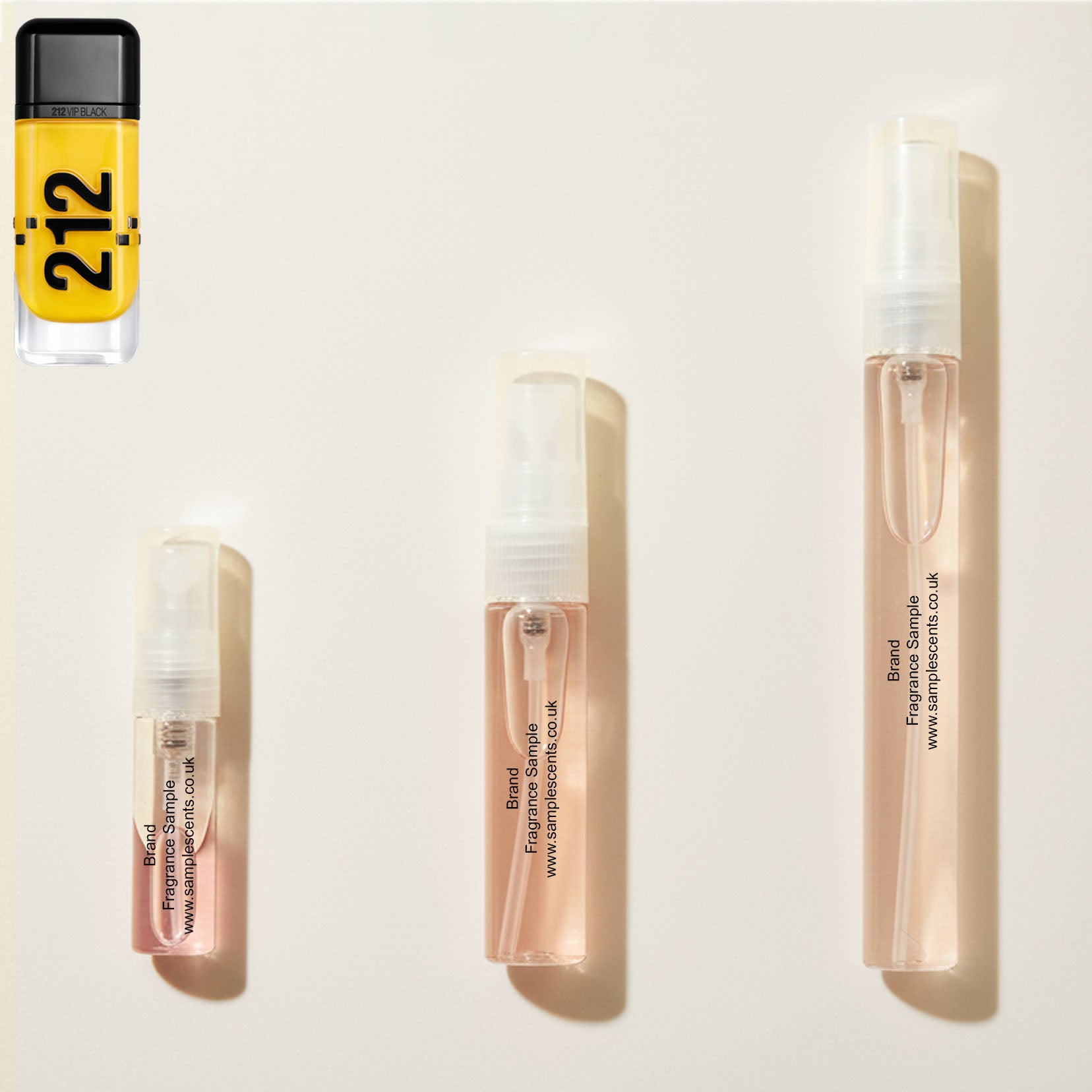 Perfume sample atomisers shown for size reference, hand-decanted from Carolina Herrera VIP Black Cab bottle.