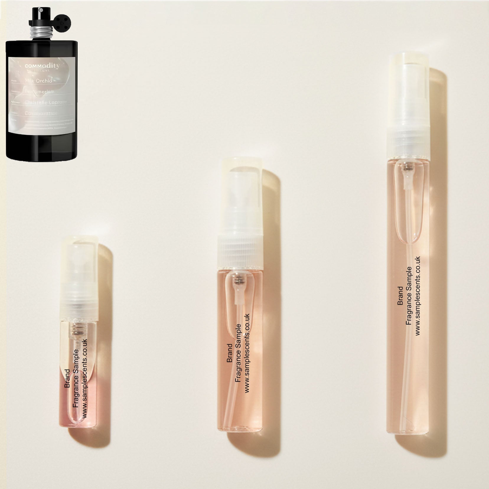 Perfume sample atomisers shown for size reference, hand-decanted from Commodity Milk Orchid bottle.