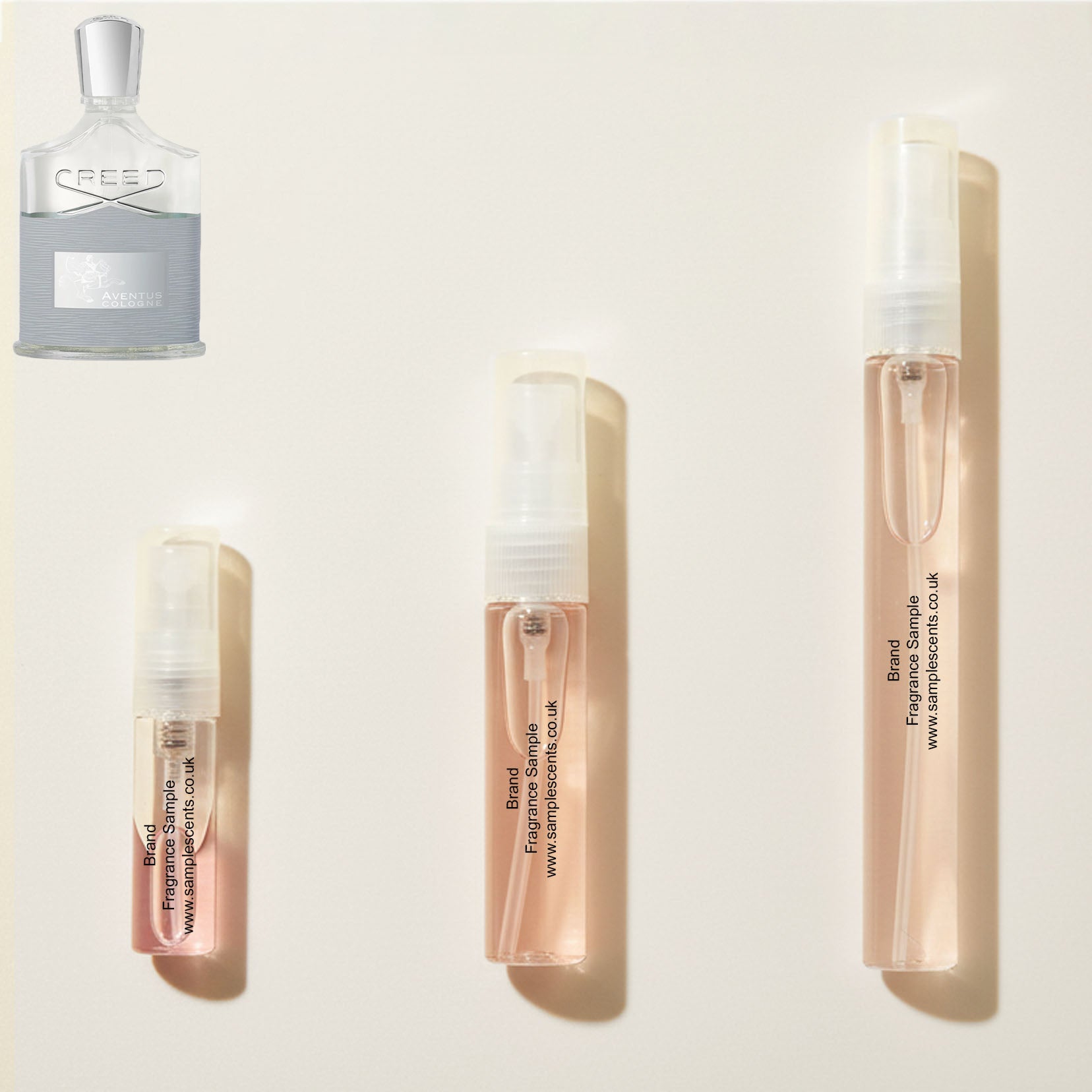 Perfume sample atomisers shown for size reference, hand-decanted from Creed Aventus Cologne bottle.