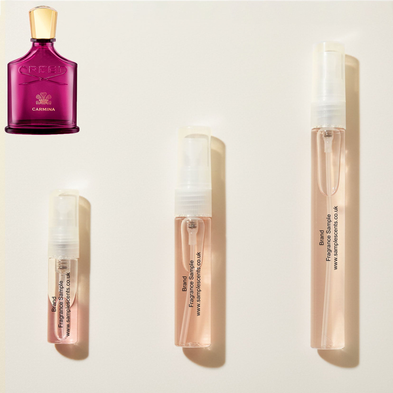 Perfume sample atomisers shown for size reference, hand-decanted from Creed Carmina bottle.