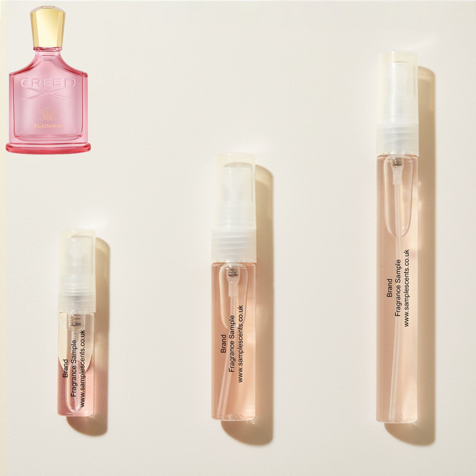 Perfume sample atomisers shown for size reference, hand-decanted from Creed Eladaria bottle.