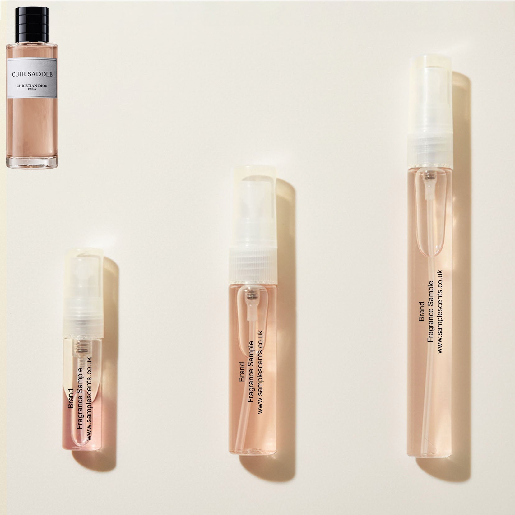 Perfume sample atomisers shown for size reference, hand-decanted from Dior Cuir Saddle bottle.