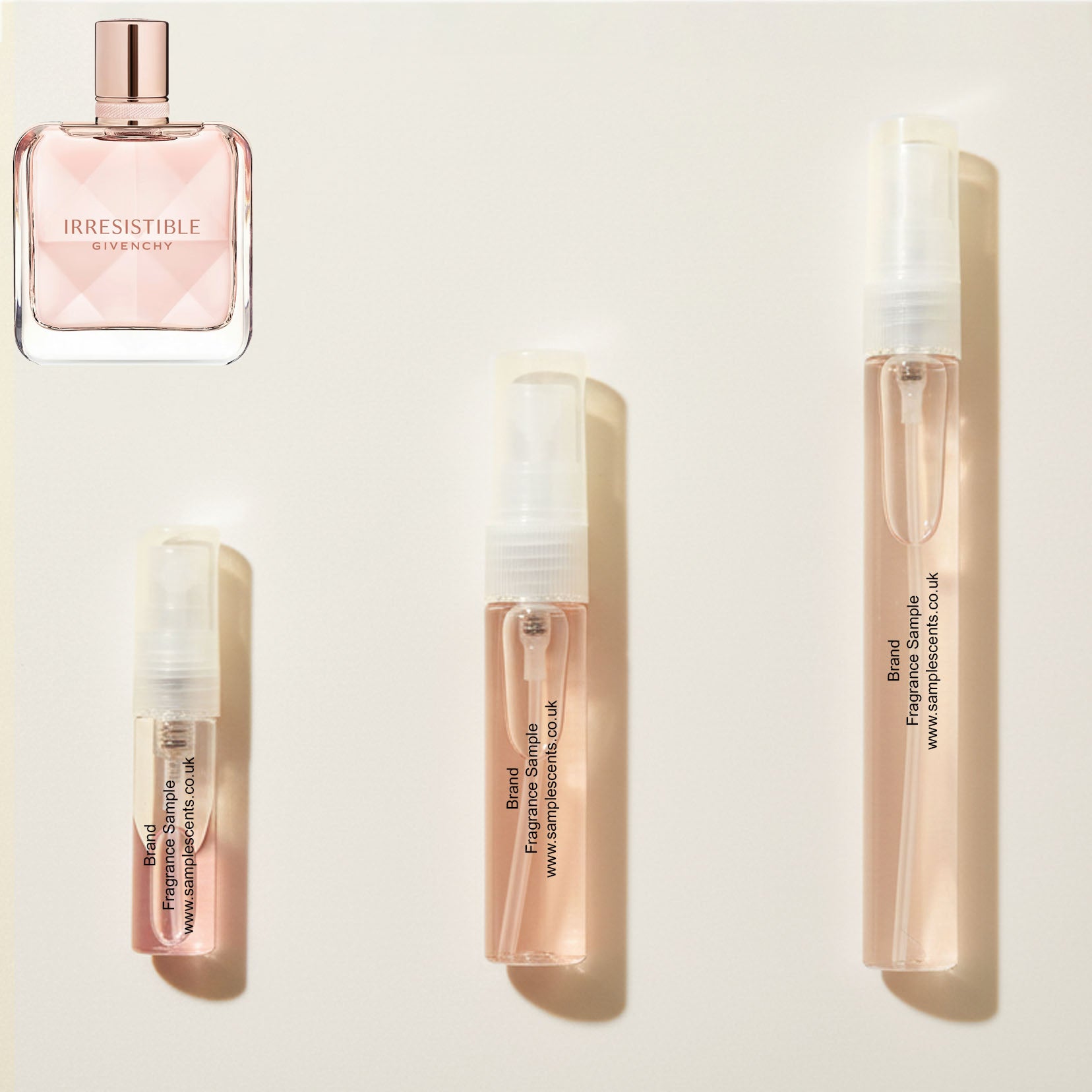 Perfume sample atomisers shown for size reference, hand-decanted from Givenchy Irresistible bottle.