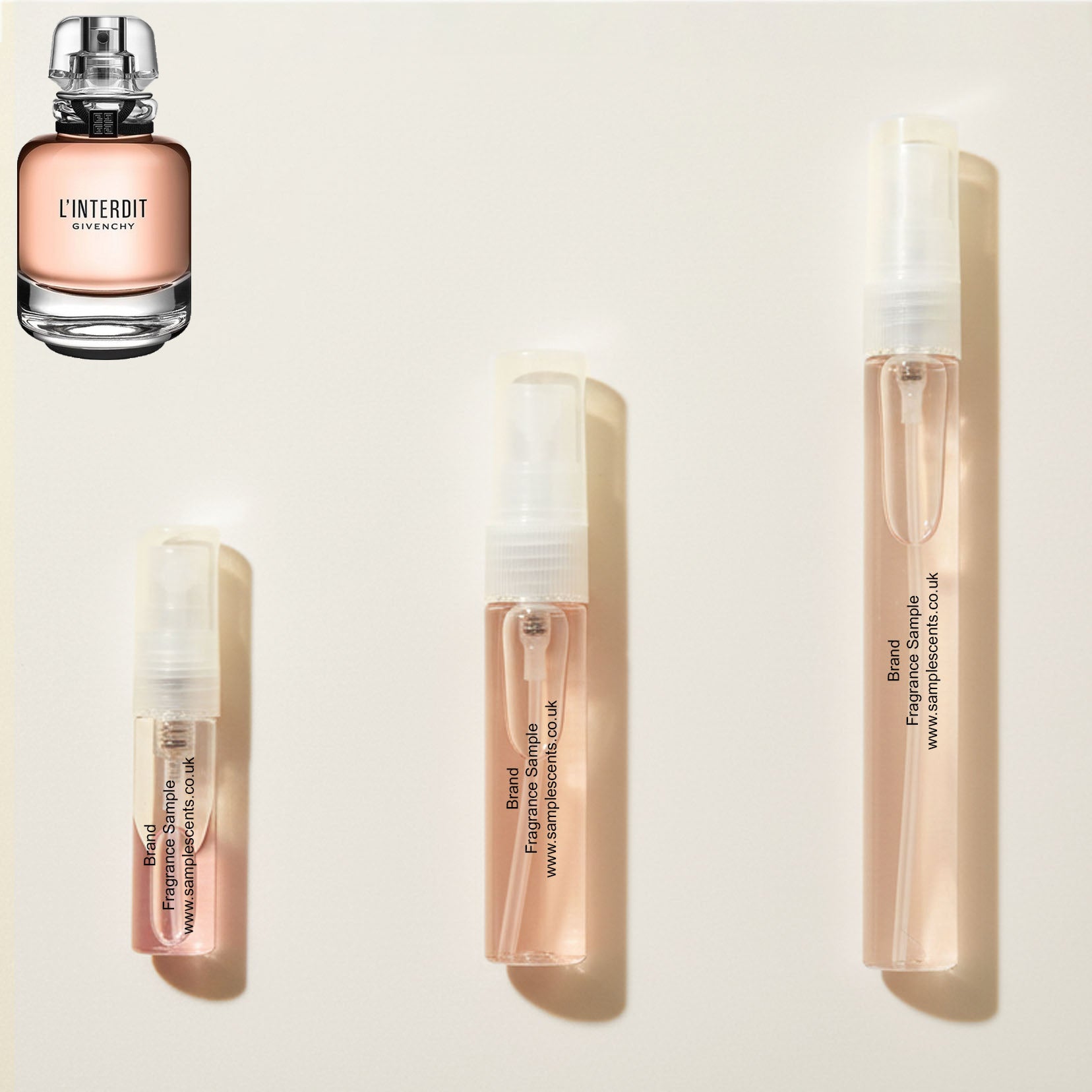 Perfume sample atomisers shown for size reference, hand-decanted from Givenchy L'Interdit bottle.