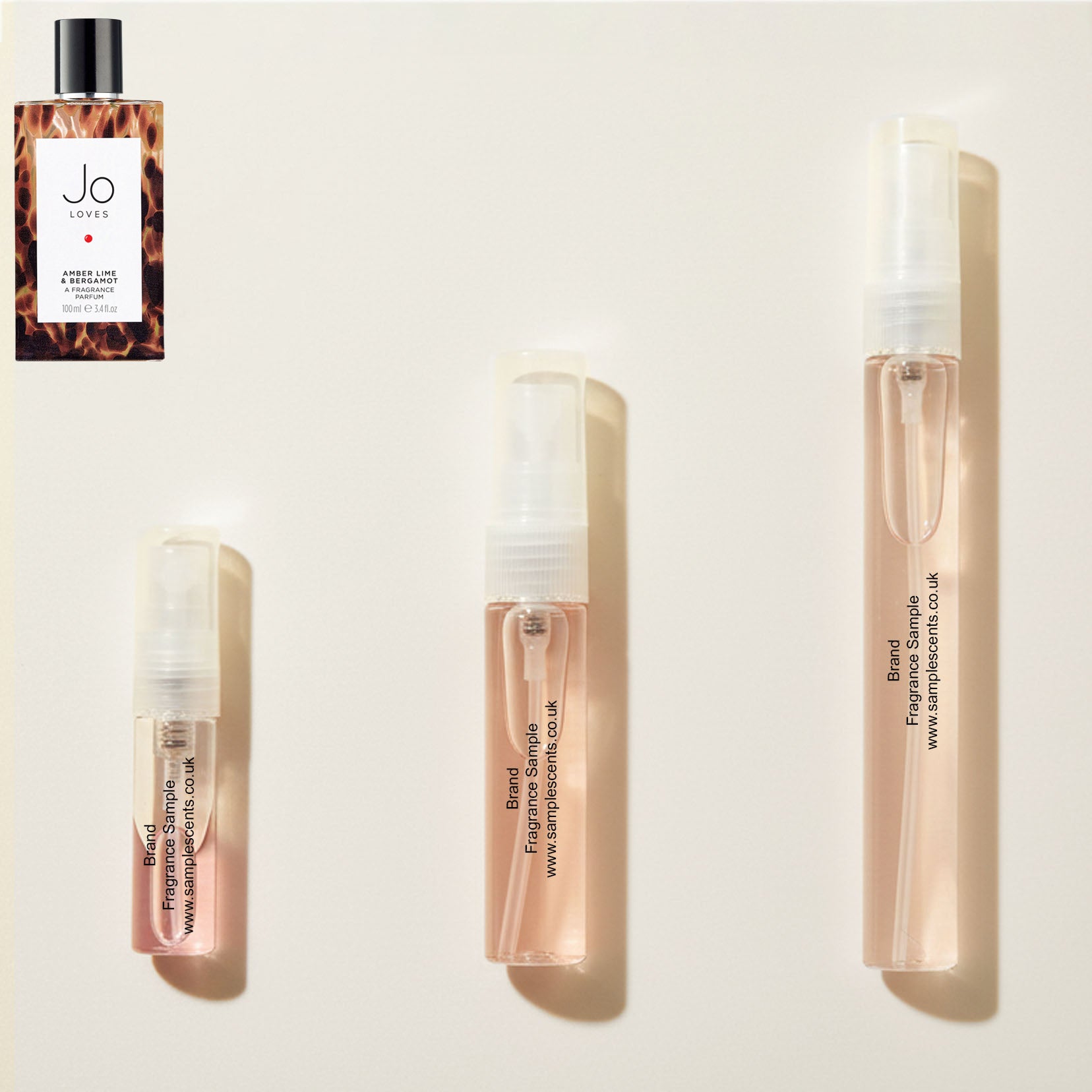 Perfume sample atomisers shown for size reference, hand-decanted from Jo Loves Amber, Lime & Bergamot bottle.