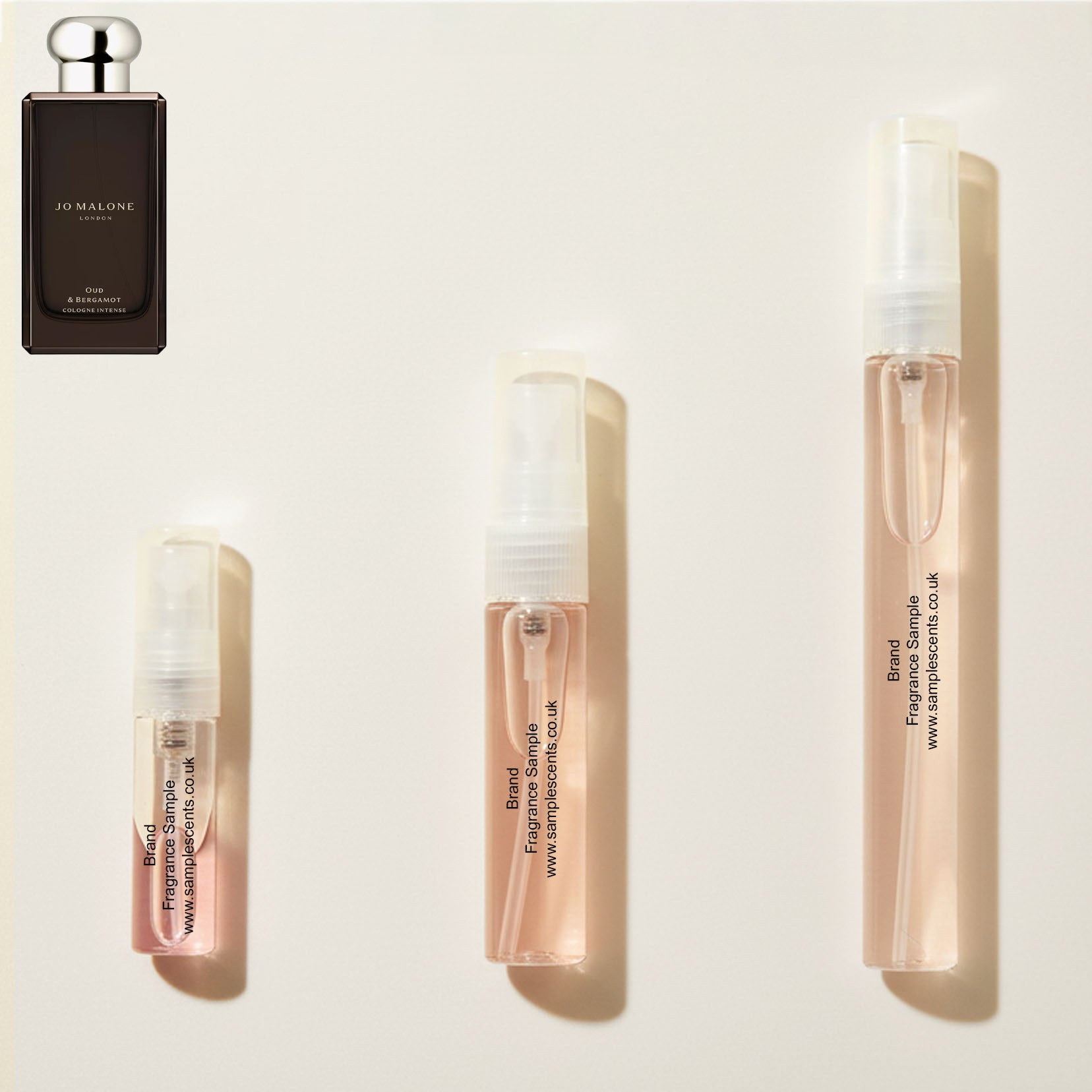 Perfume sample atomisers shown for size reference, hand-decanted from Jo Malone London Oud & Bergamot bottle.