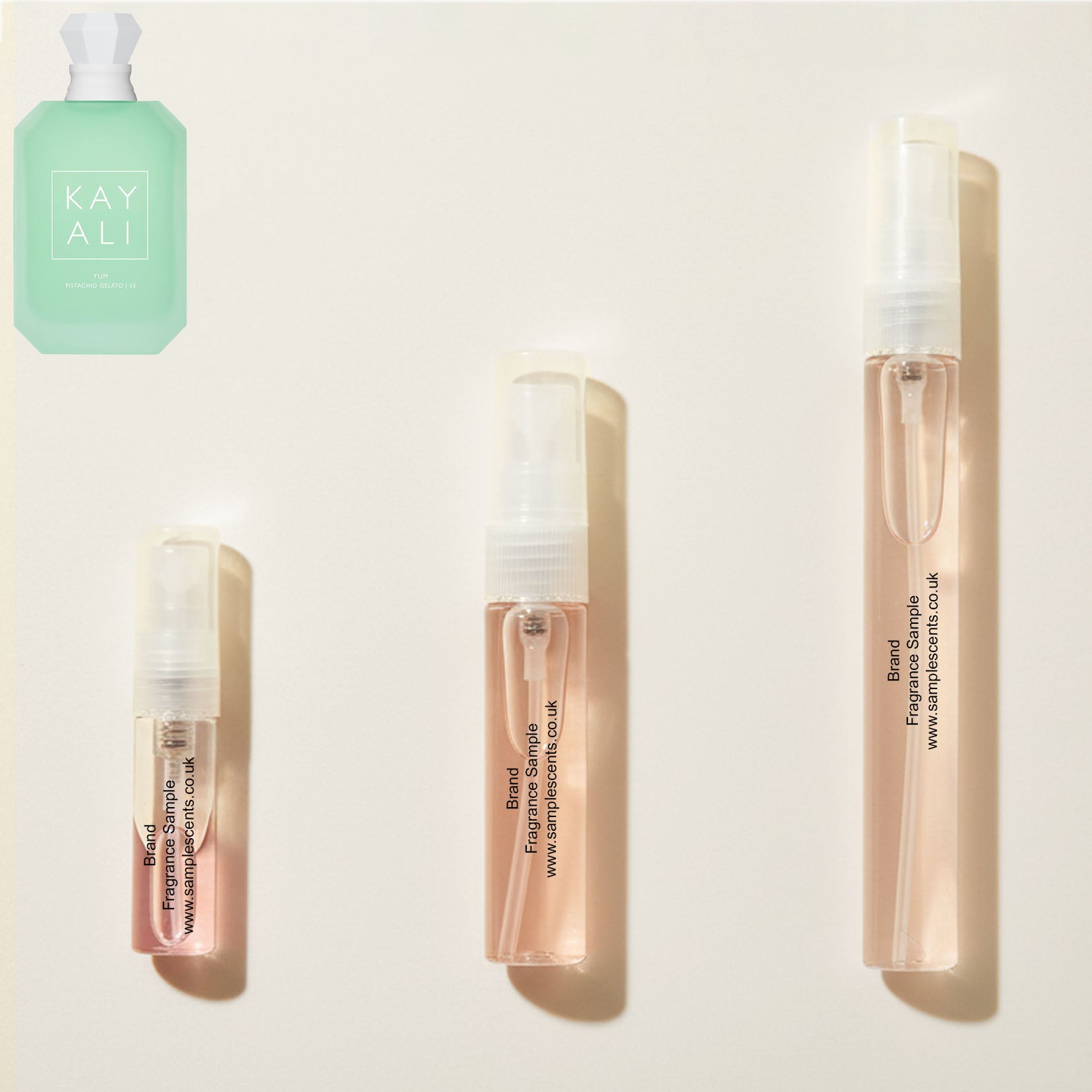 Perfume sample atomisers shown for size reference, hand-decanted from Kayali Yum Pistachio Gelato 33 bottle.