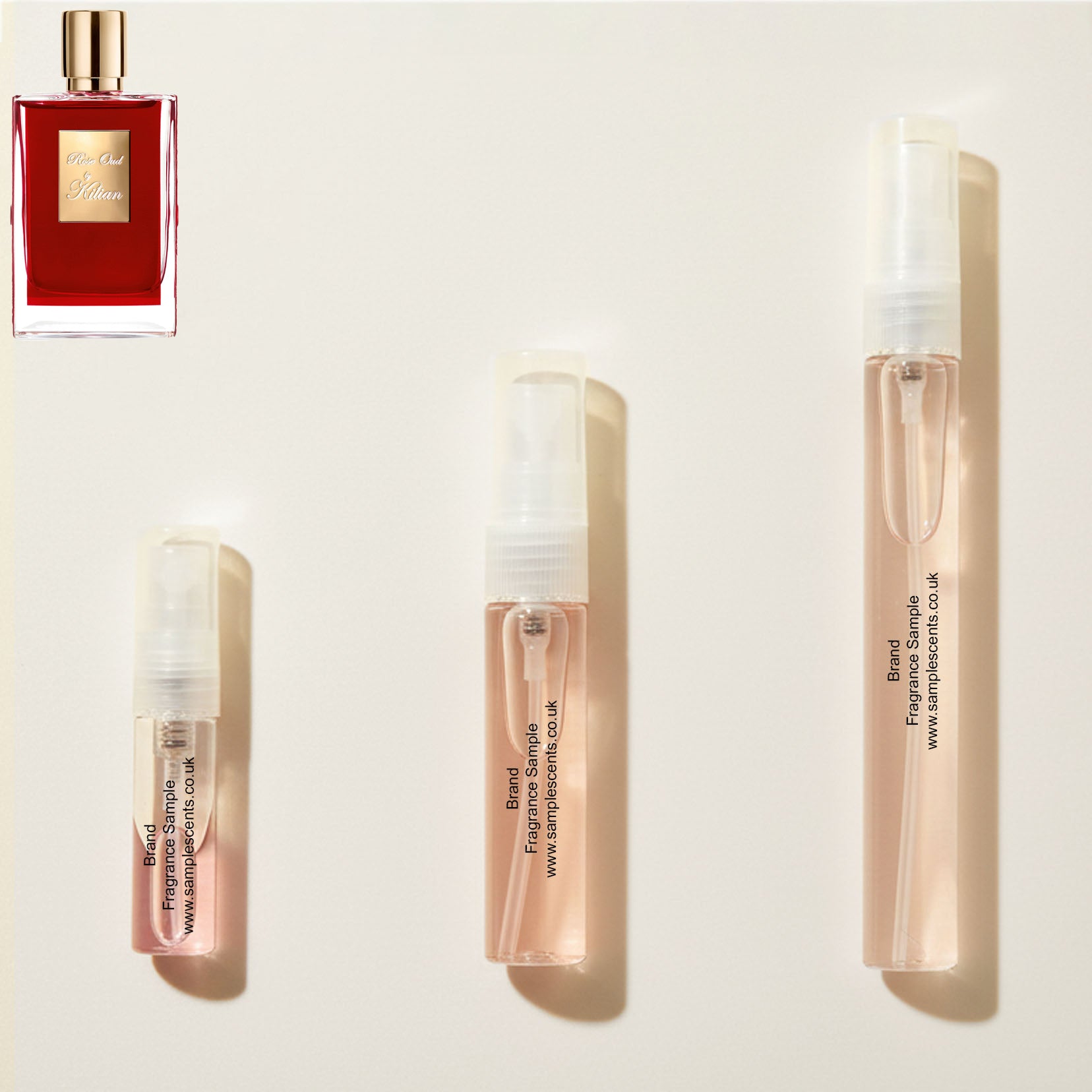 Perfume sample atomisers shown for size reference, hand-decanted from Kilian Rose Oud bottle.