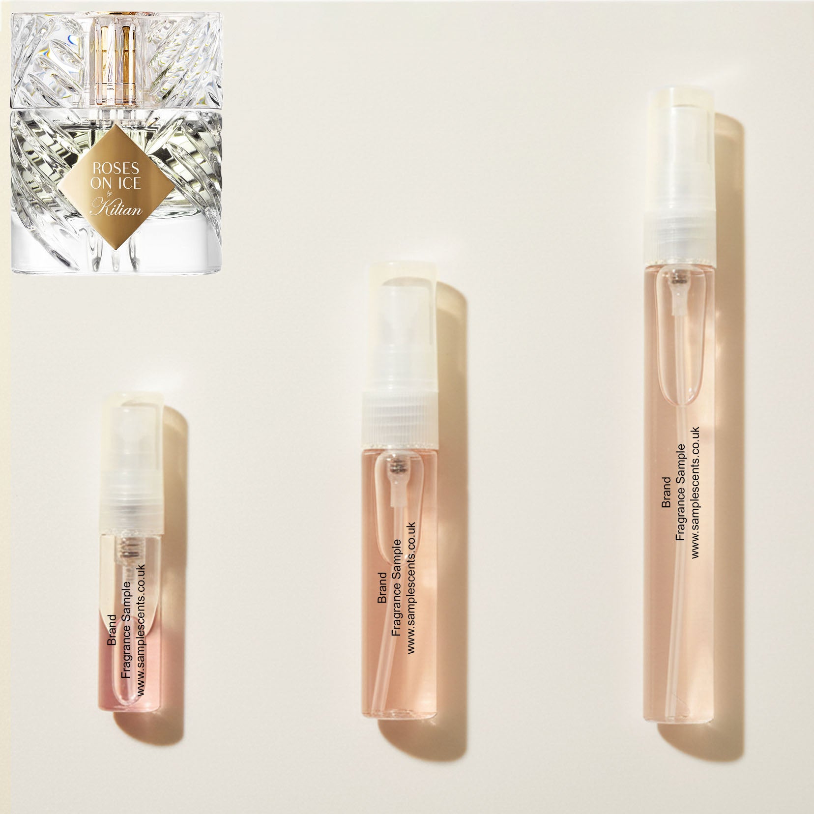 Perfume sample atomisers shown for size reference, hand-decanted from Kilian Roses On Ice bottle.