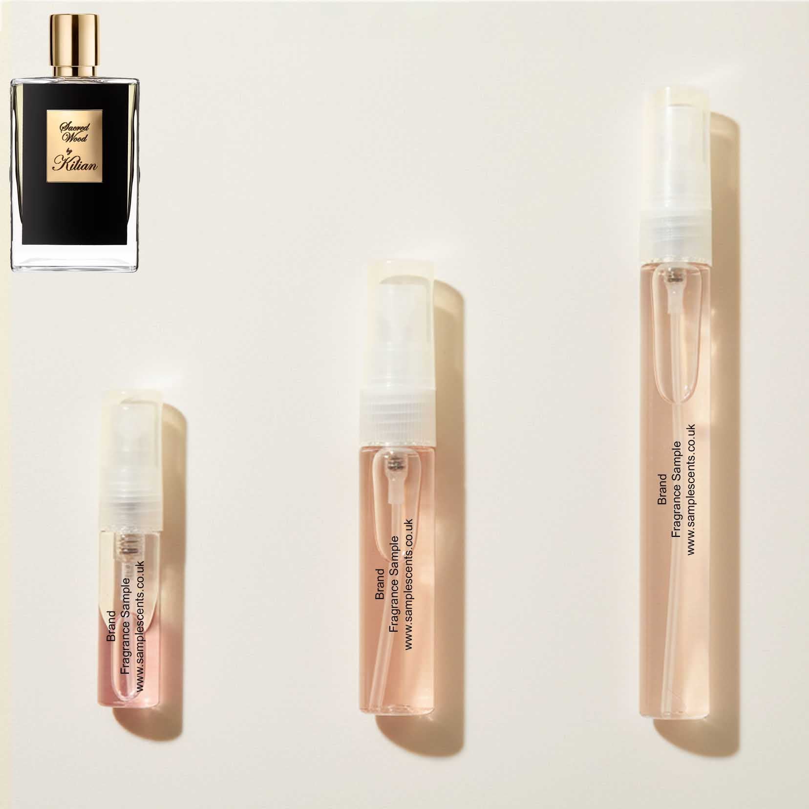 Perfume sample atomisers shown for size reference, hand-decanted from Kilian Sacred Wood bottle.