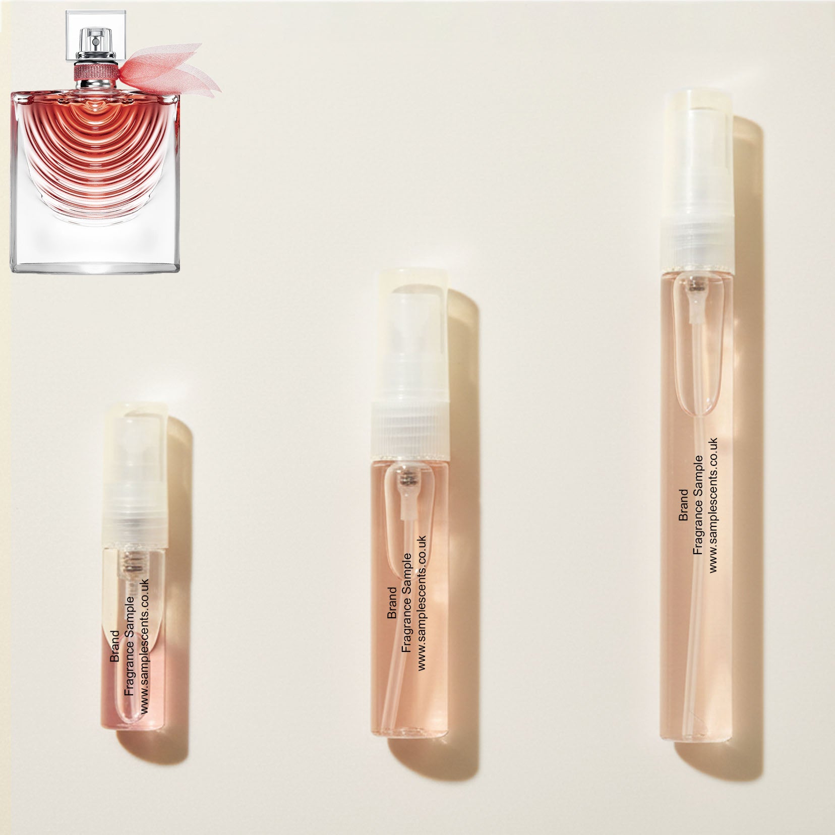 Perfume sample atomisers shown for size reference, hand-decanted from Lancome La Vie Est Belle Iris Absolu bottle.
