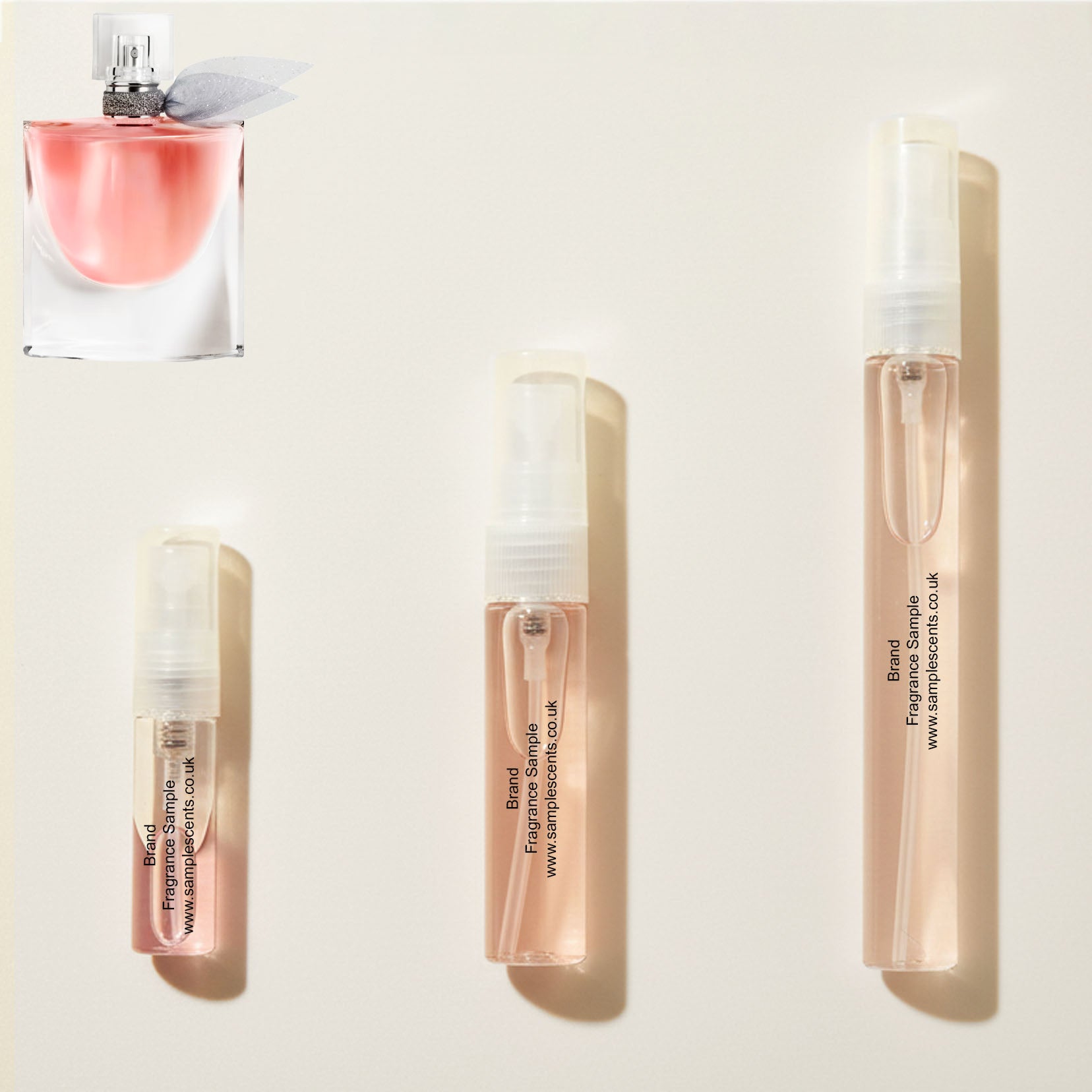 Perfume sample atomisers shown for size reference, hand-decanted from Lancome La Vie Est Belle bottle.