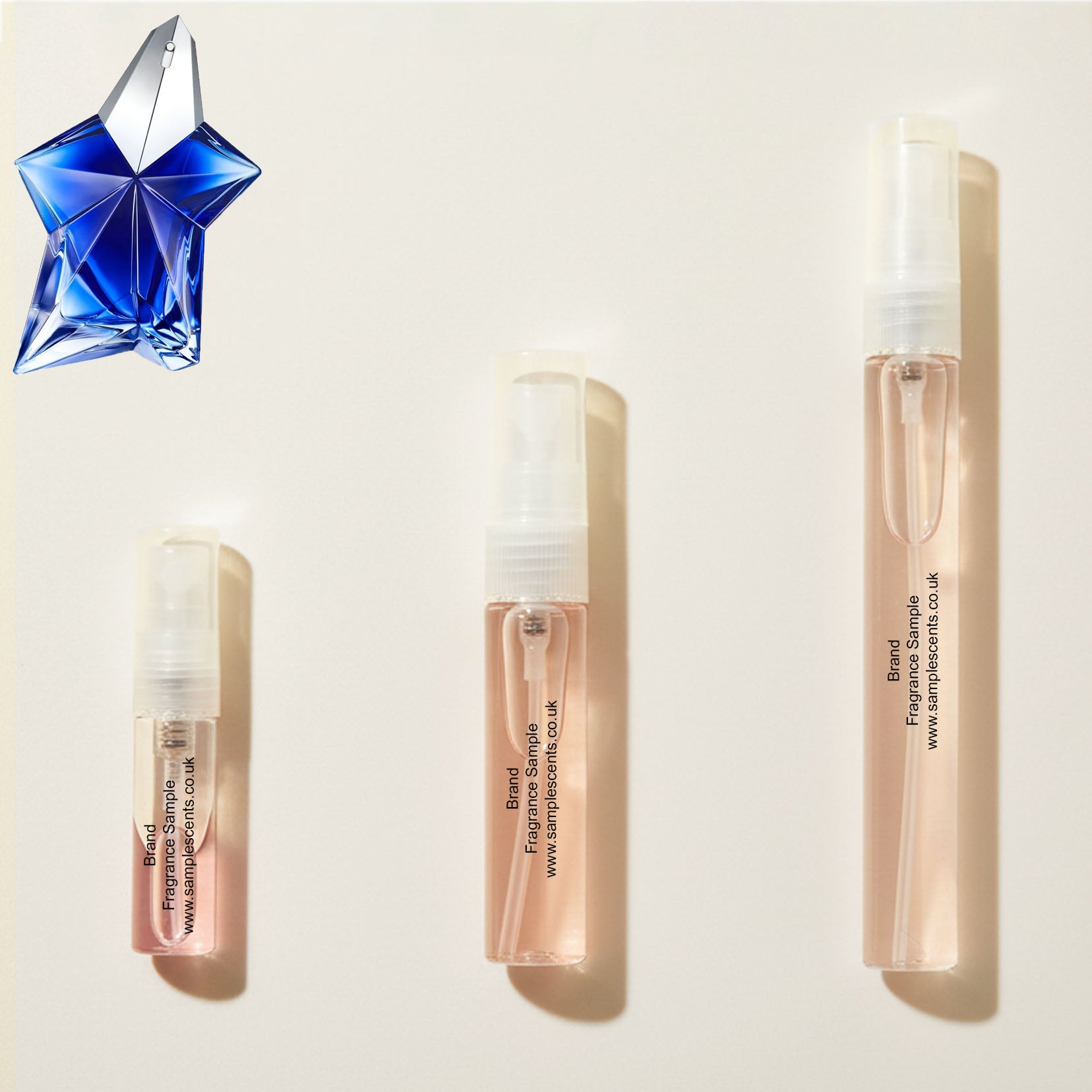Perfume sample atomisers shown for size reference, hand-decanted from Mugler Angel Stellar bottle.