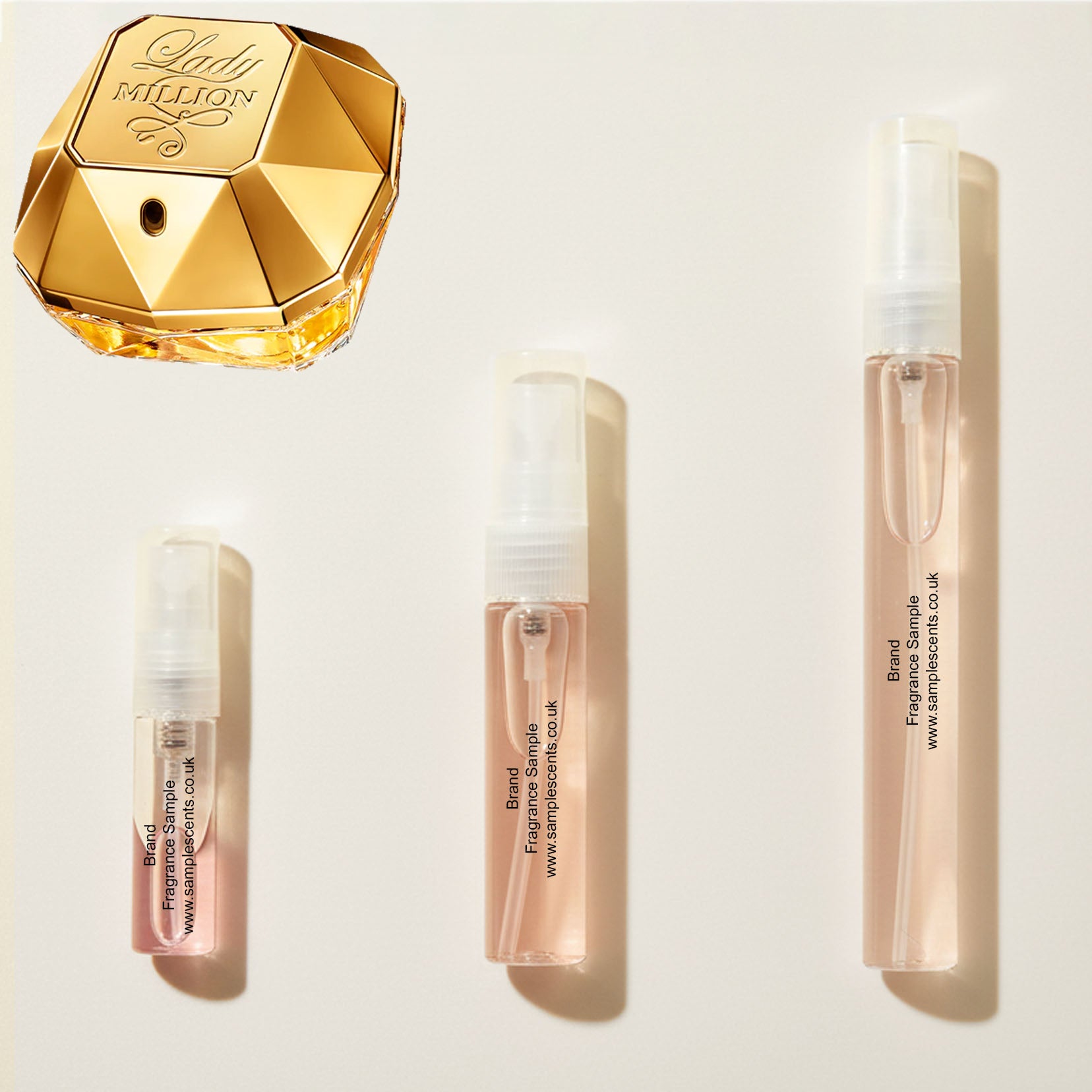 Perfume sample atomisers shown for size reference, hand-decanted from Paco Rabane Lady Million bottle.