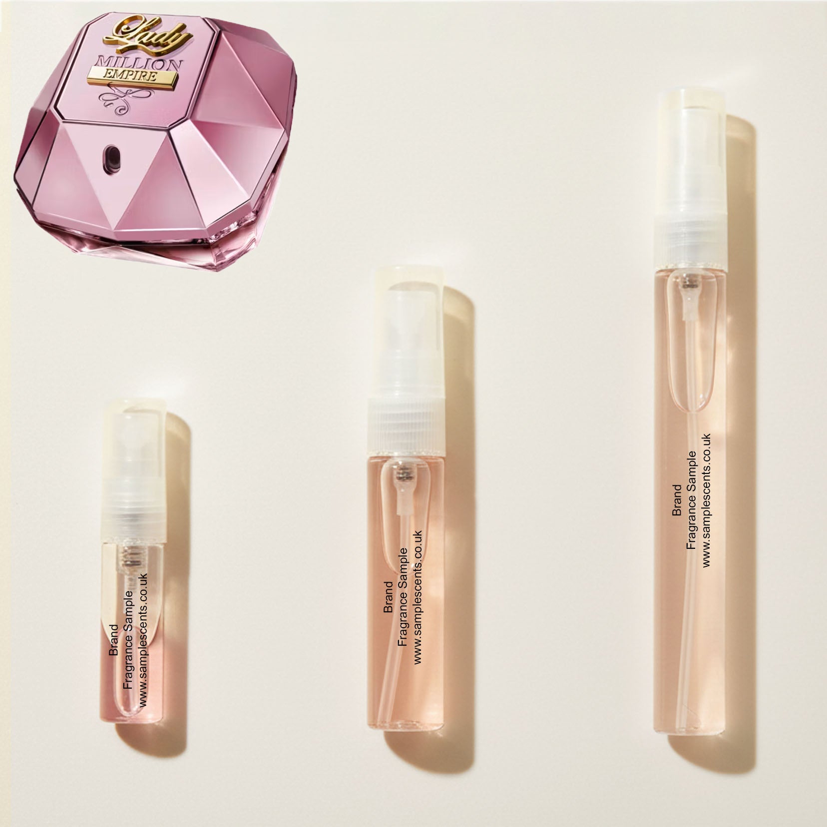 Perfume sample atomisers shown for size reference, hand-decanted from Paco Rabanne Lady Million Empire bottle.