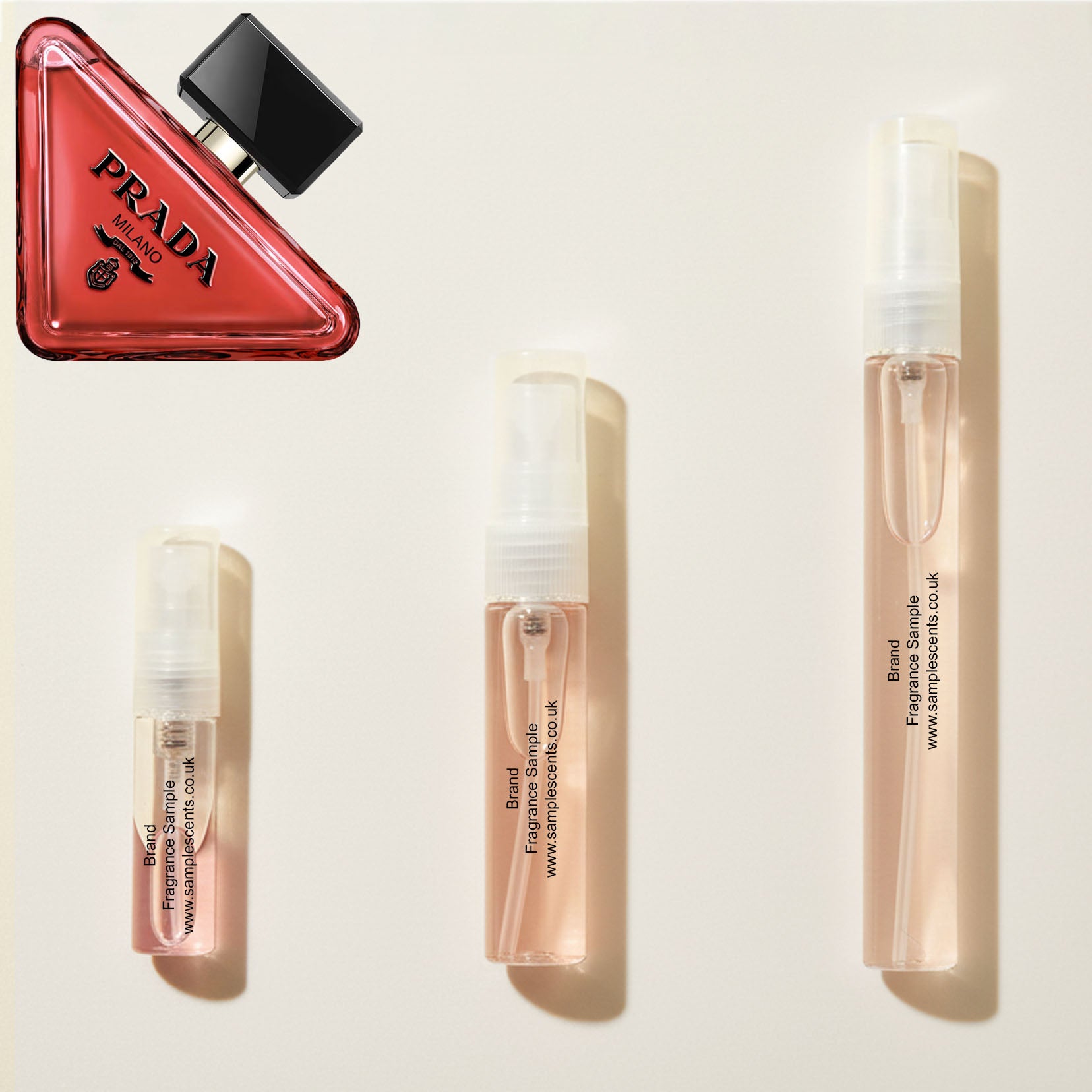 Perfume sample atomisers shown for size reference, hand-decanted from Prada Paradoxe Radical Essence bottle.