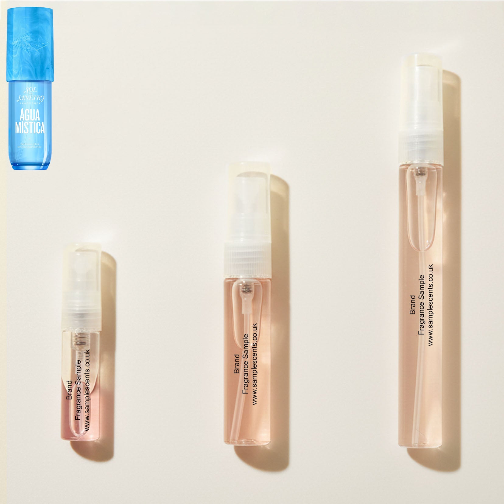 Perfume sample atomisers shown for size reference, hand-decanted from Sol De Janeiro Agua Mistica bottle.