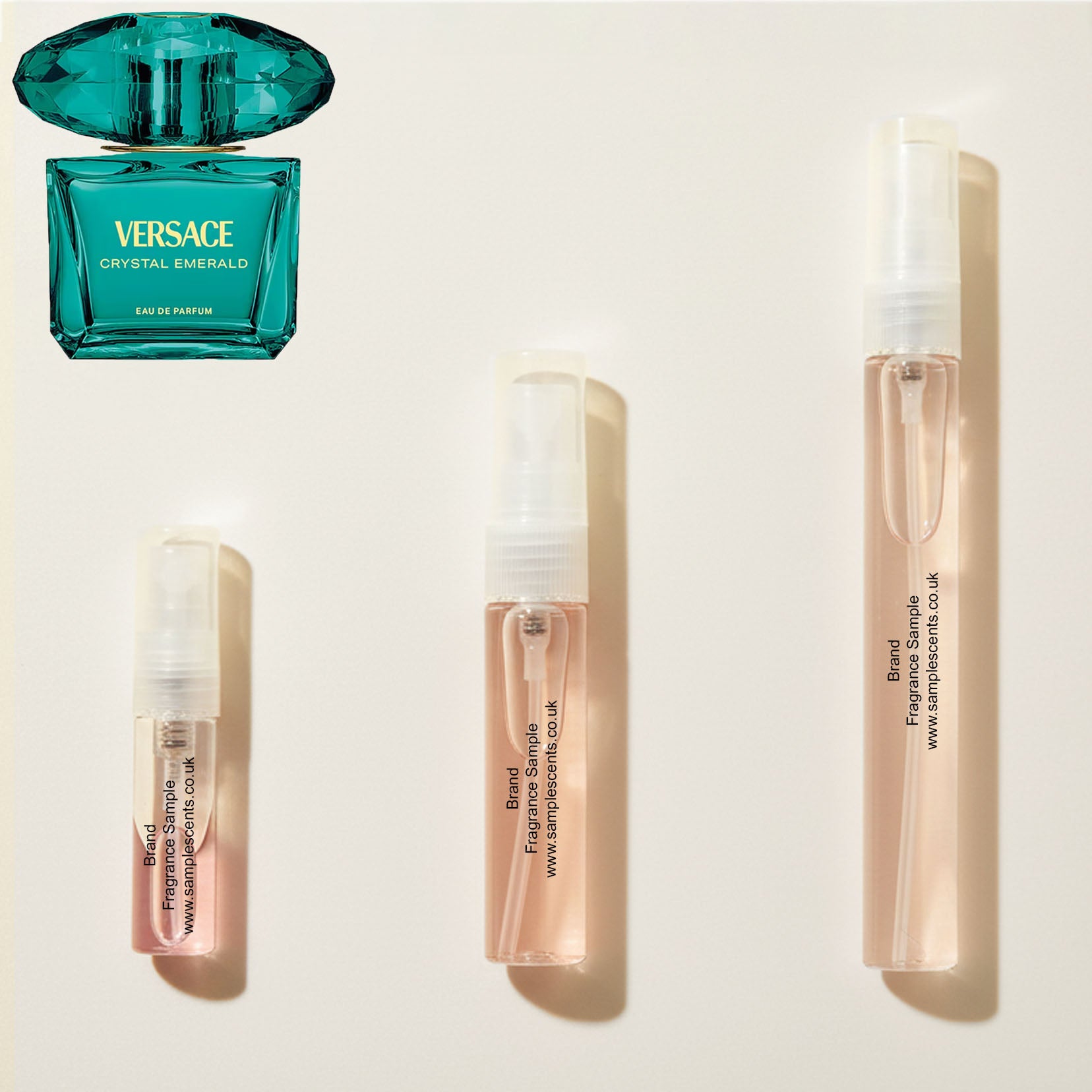 Perfume sample atomisers shown for size reference, hand-decanted from Versace Crystal Emerald bottle.