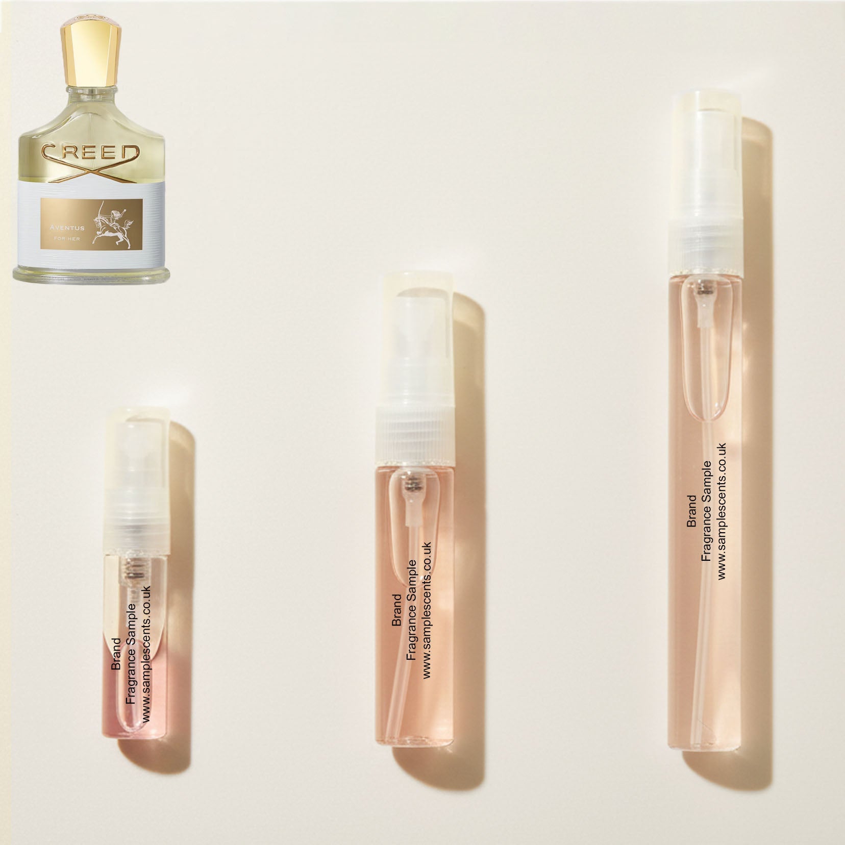 Perfume sample atomisers shown for size reference, hand-decanted from Creed Aventus For Her bottle.