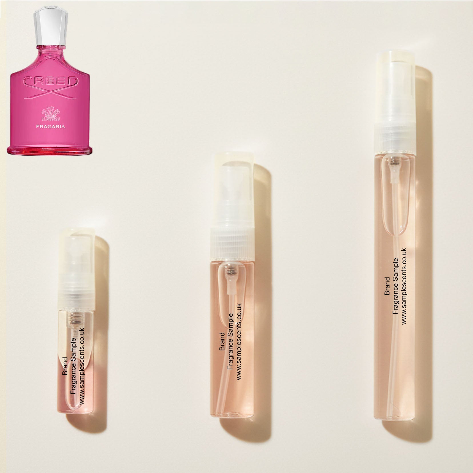 Perfume sample atomisers shown for size reference, hand-decanted from Creed Fragaria bottle.