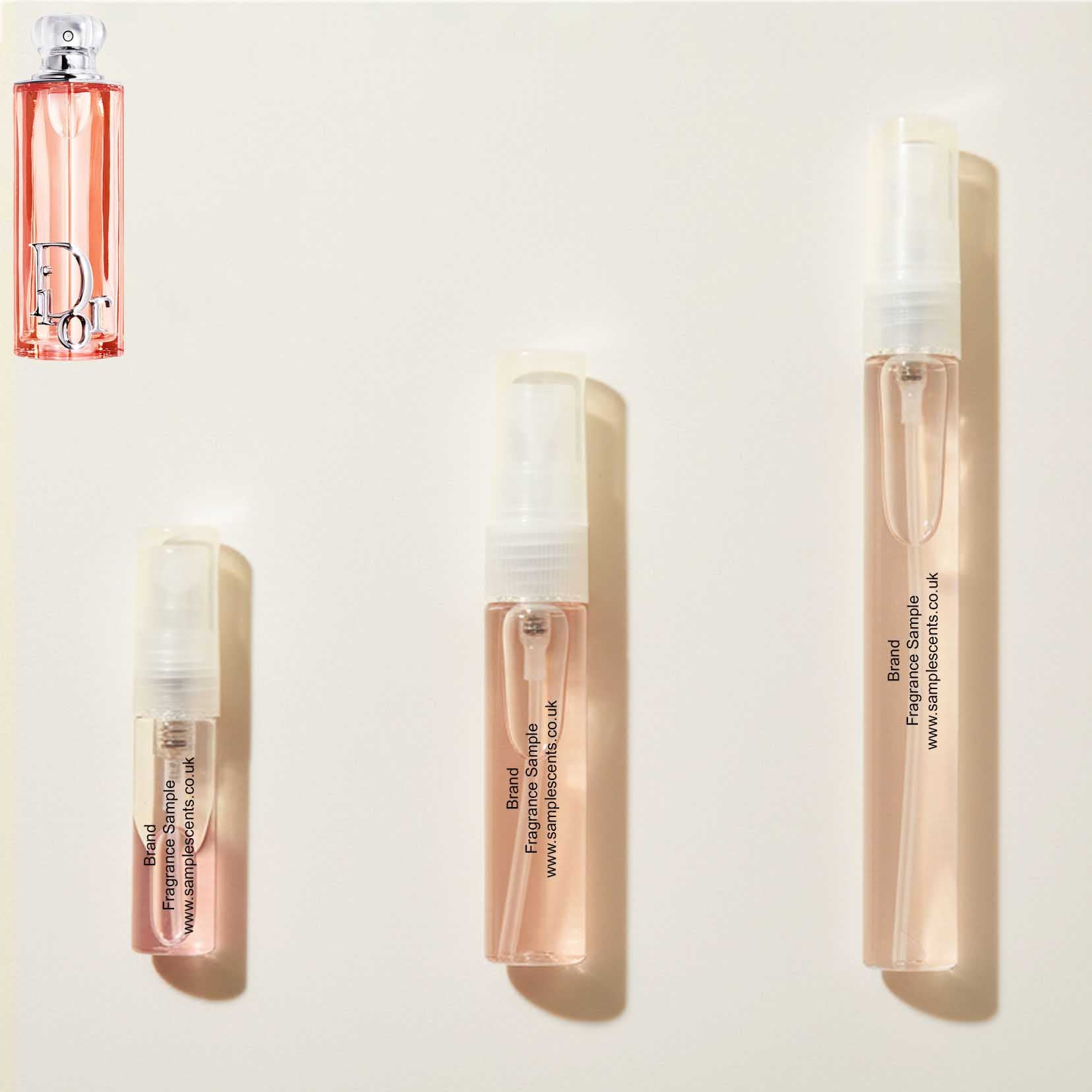 Perfume sample atomisers shown for size reference, hand-decanted from Dior Addict Peachy Glow bottle.