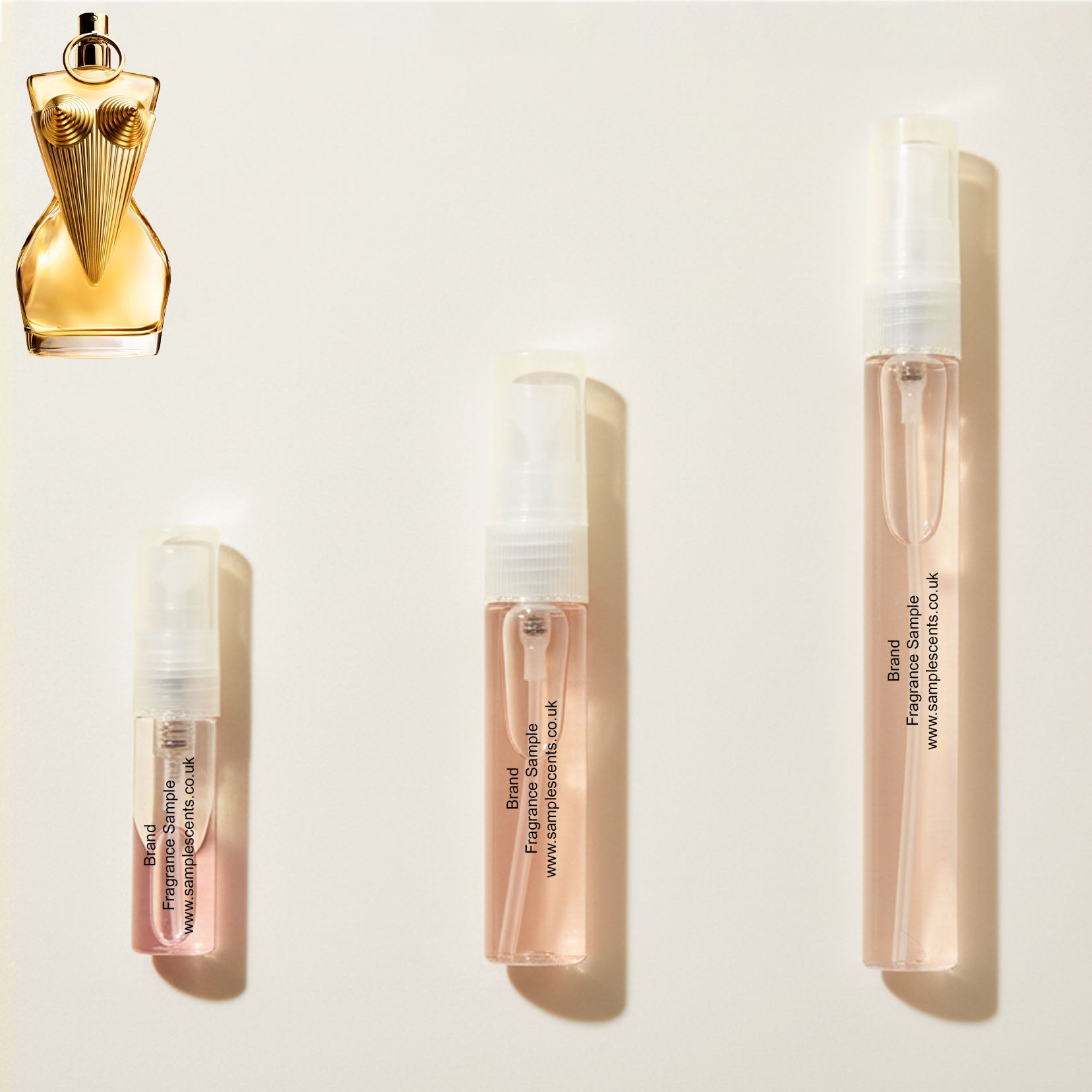 Perfume sample atomisers shown for size reference, hand-decanted from Jean Paul Gaultier Divine bottle.