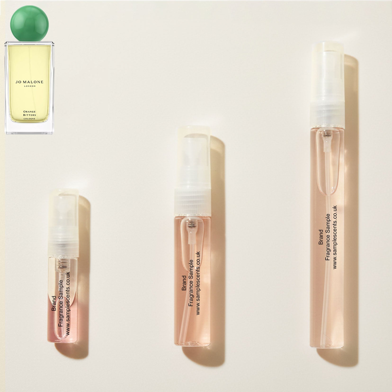 Perfume sample atomisers shown for size reference, hand-decanted from Jo Malone London Orange Bitters bottle.