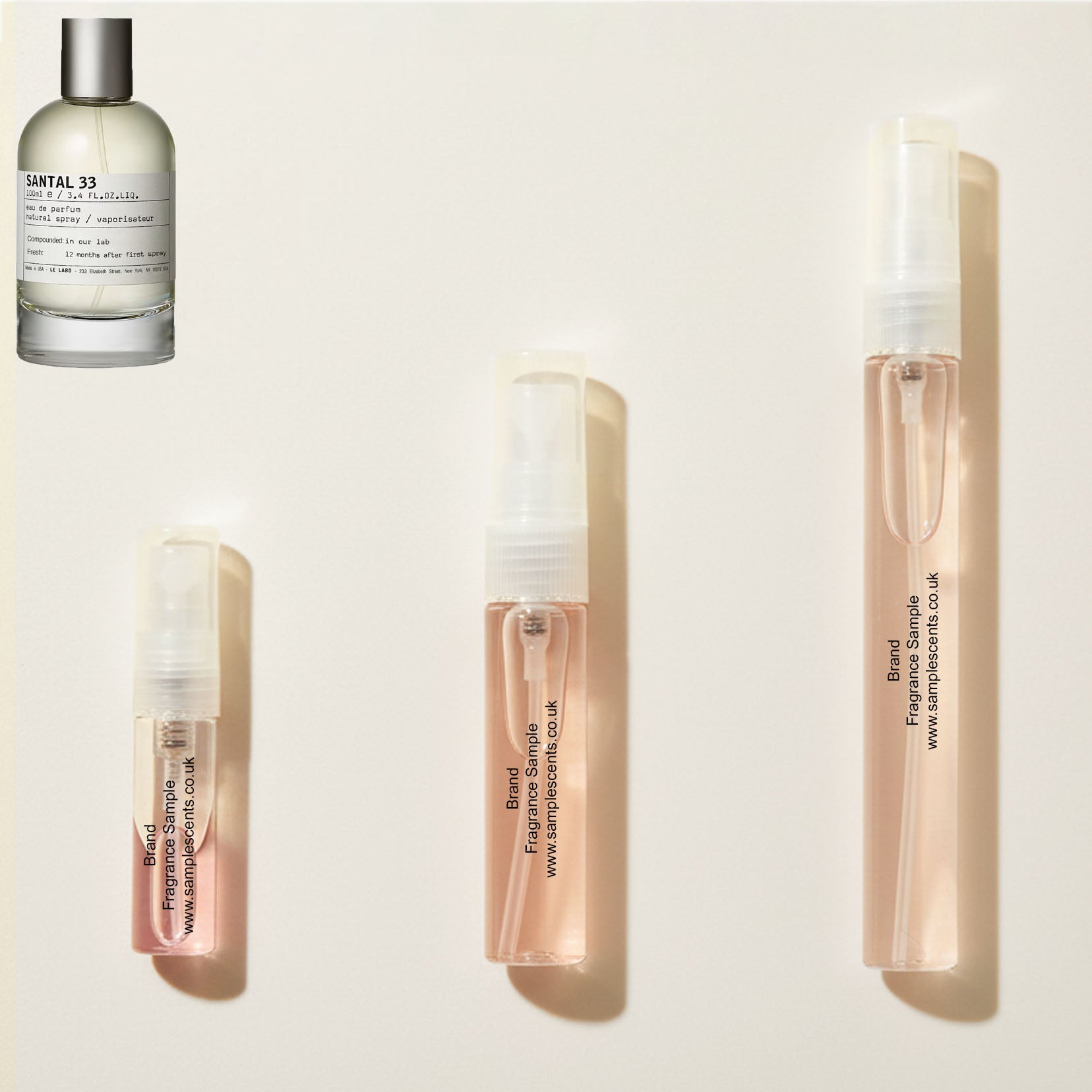 Perfume sample atomisers shown for size reference, hand-decanted from Le Labo Santal 33 bottle.