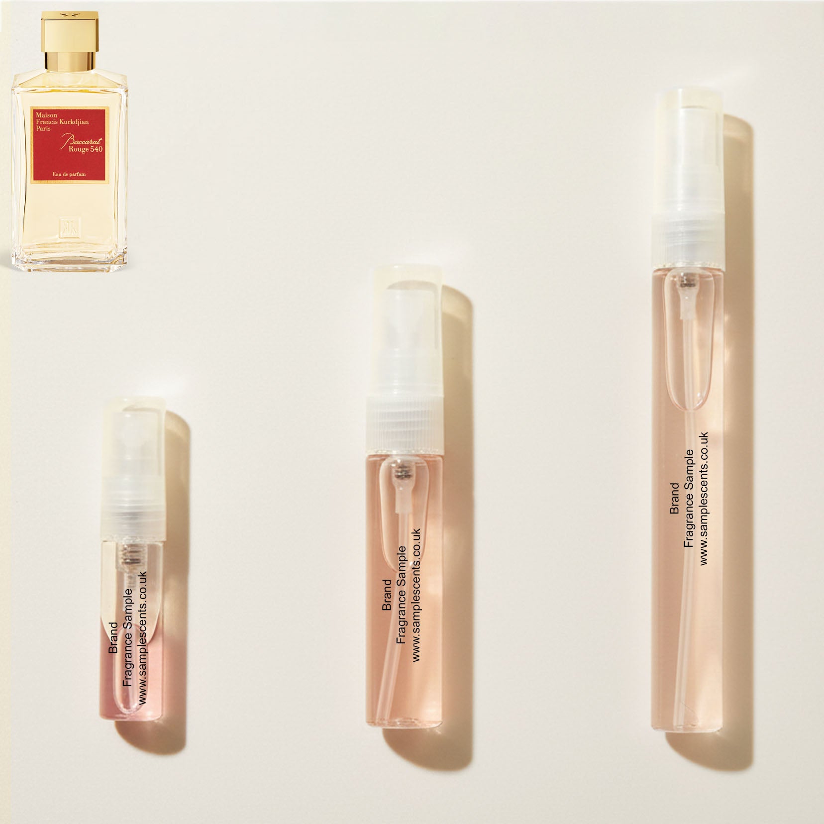 Perfume sample atomisers shown for size reference, hand-decanted from Maison Francis Kurkdjian Baccarat Rouge 540 bottle.