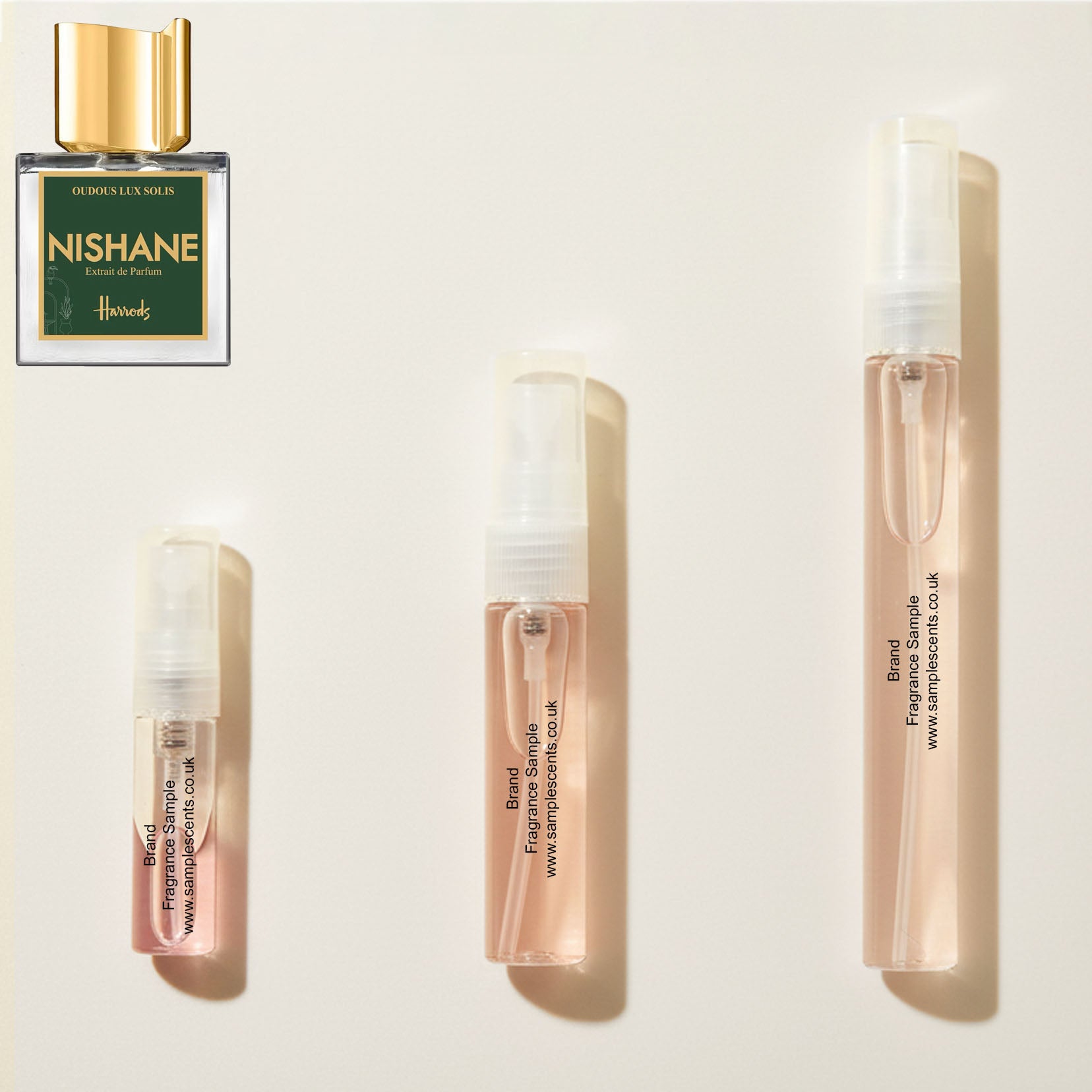Perfume sample atomisers shown for size reference, hand-decanted from Nishane Oudous Lux Solis bottle.