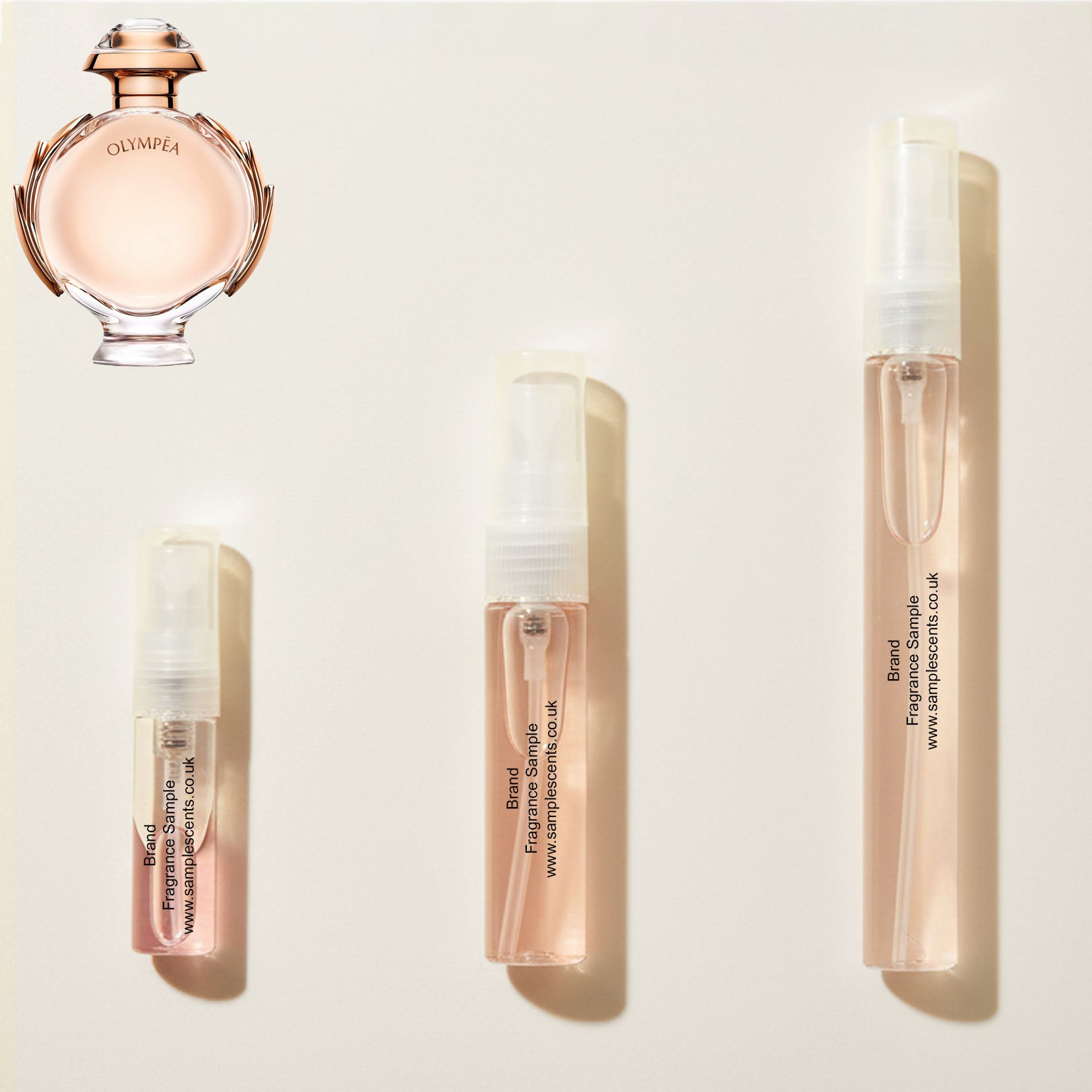 Perfume sample atomisers shown for size reference, hand-decanted from Paco Rabanne Olympea bottle.