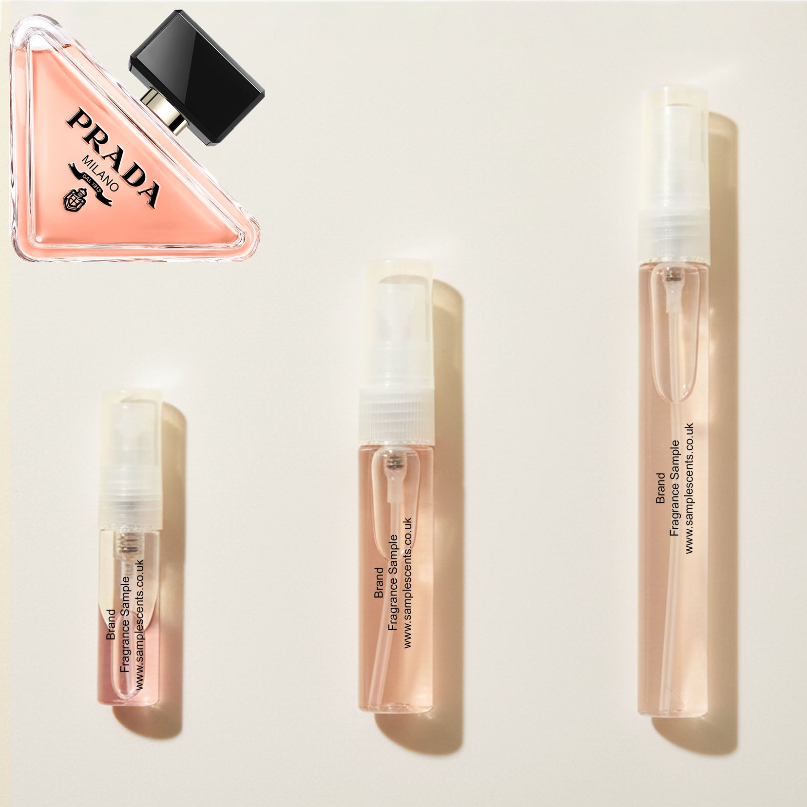 Perfume sample atomisers shown for size reference, hand-decanted from Prada Paradoxe bottle.