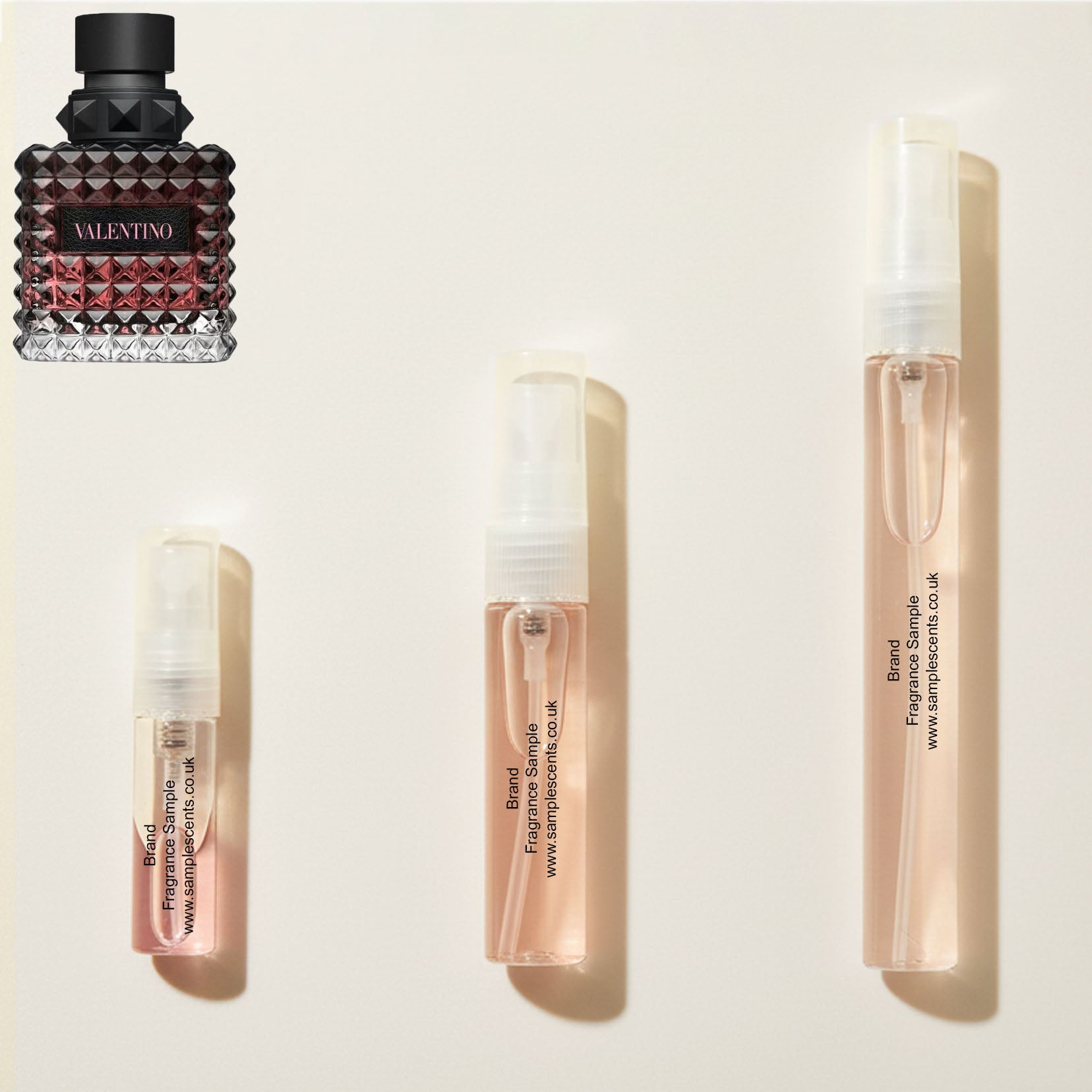 Perfume sample atomisers shown for size reference, hand-decanted from Valentino Born In Roma Donna Intense bottle.