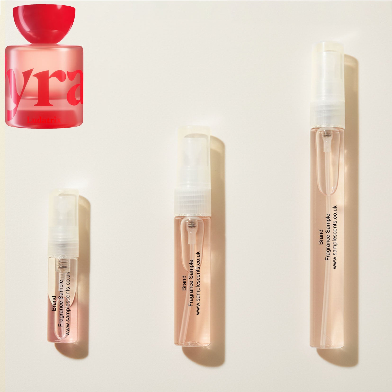 Perfume sample atomisers shown for size reference, hand-decanted from Vyrao Ludatrix bottle.