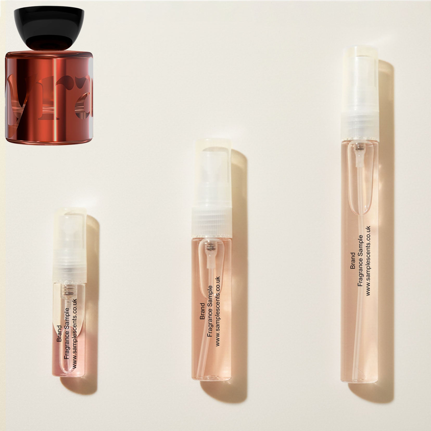 Perfume sample atomisers shown for size reference, hand-decanted from Vyrao Mamajuju bottle.